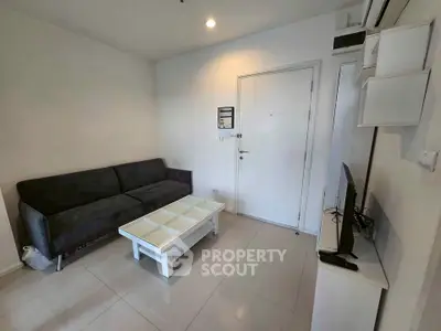 Modern living room with sleek furniture and minimalist design in a cozy apartment.