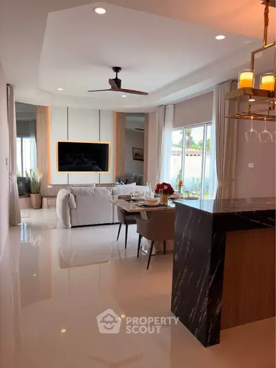 Luxurious open-plan living room with modern decor and elegant lighting