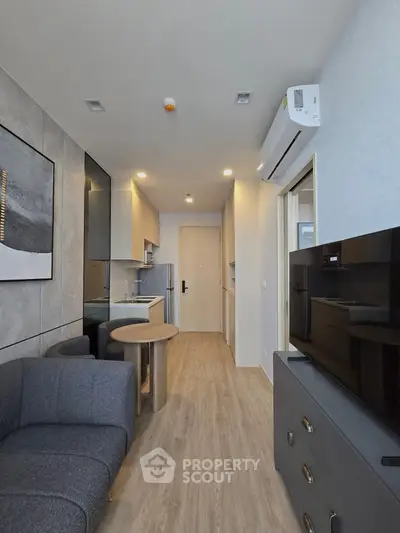 Modern living room with sleek kitchen and stylish decor