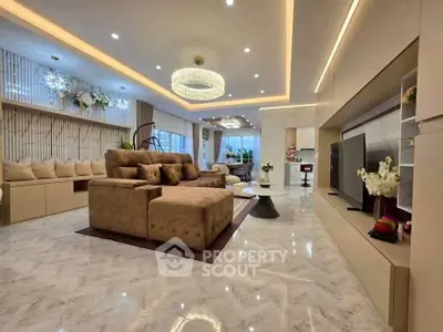 Luxurious open-plan living room with elegant decor and modern lighting, perfect for entertaining.