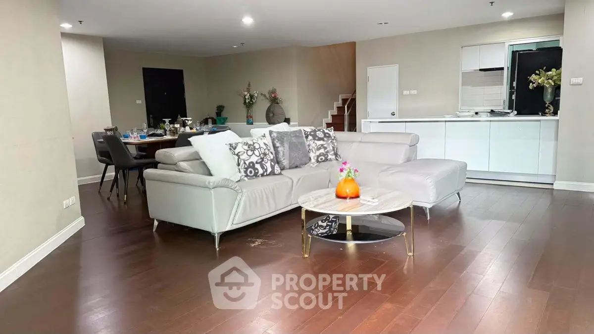Spacious modern living room with elegant decor and open kitchen layout