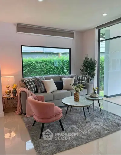 Chic modern living room with plush seating and garden view, perfect for relaxation and entertaining.
