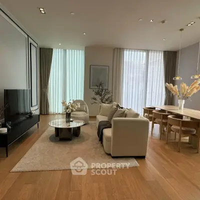 Luxurious modern living room with elegant decor and large windows, featuring a cozy seating area and stylish dining space.