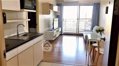 Modern open-layout living room with kitchen, featuring sleek furniture and a balcony view.