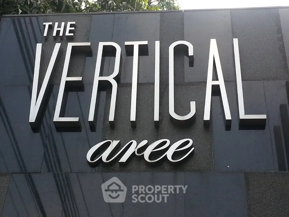 Modern building facade with stylish vertical signage in urban area.