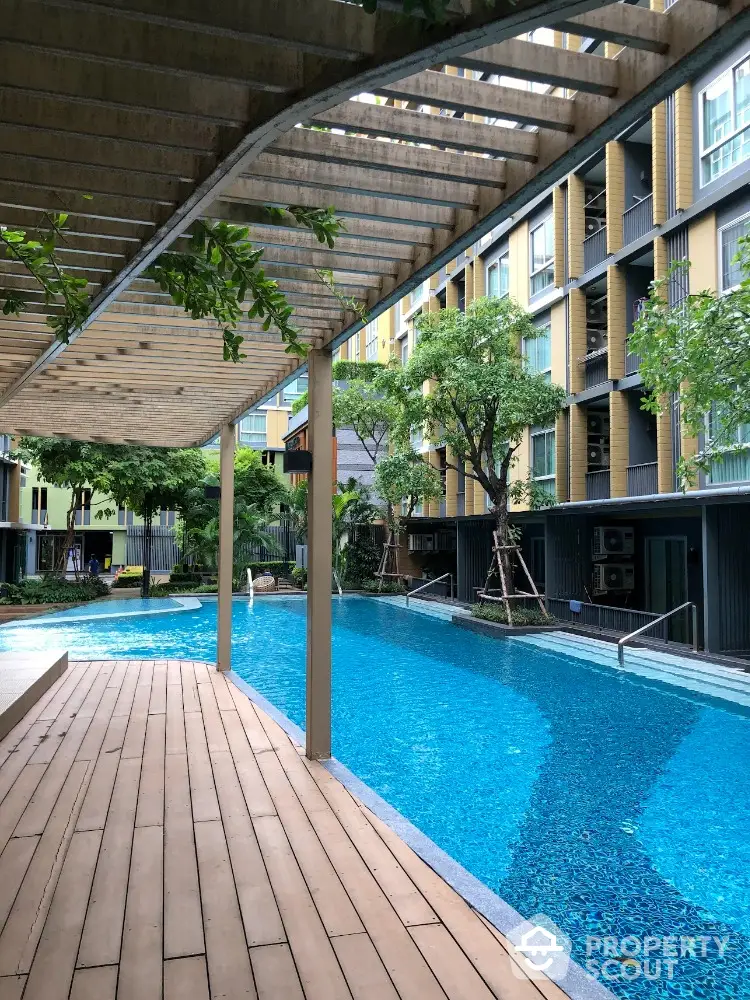 Luxurious modern apartment complex with stunning swimming pool and lush greenery