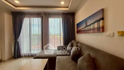 Spacious living room with modern decor and large windows offering natural light.