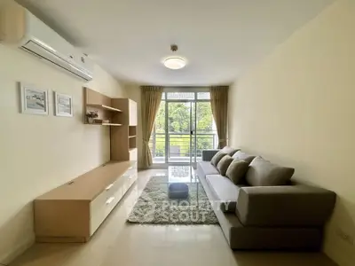Spacious living room with modern furniture and balcony view