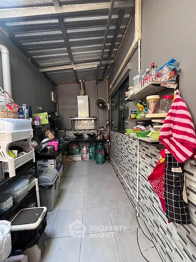 Compact kitchen with open layout and gas stove, featuring efficient storage solutions and modern design.