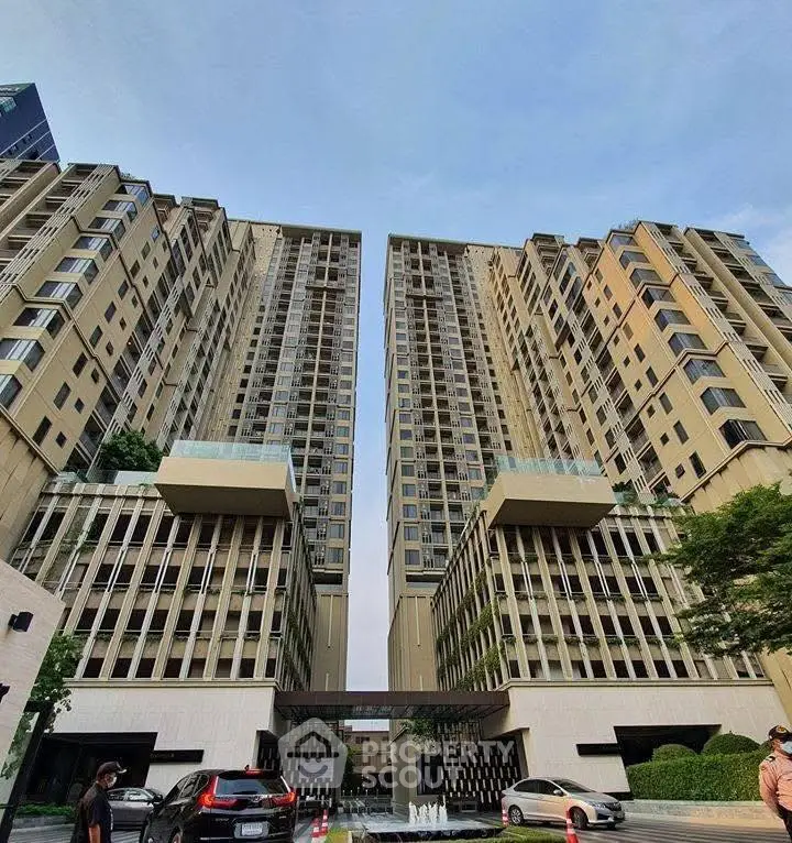 Modern high-rise residential building with spacious entrance and luxury appeal.