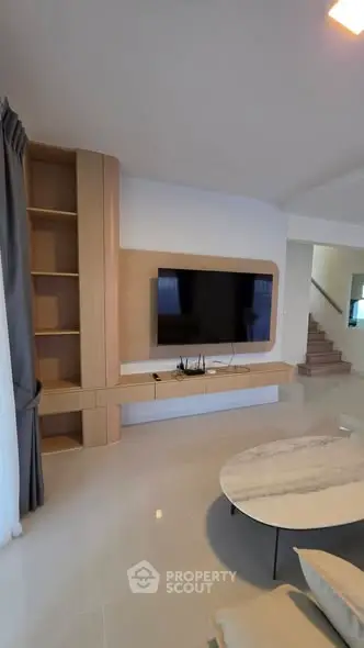Modern living room with sleek TV setup and stylish furniture