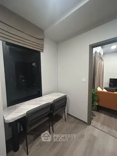 Modern apartment interior with sleek dining area and cozy living room, perfect for urban living.