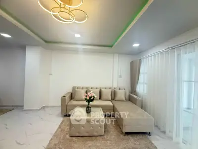 Elegant living room with modern beige sectional sofa and stylish lighting