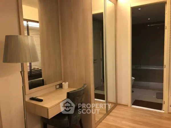 Modern bedroom with mirrored wardrobe and cozy lighting