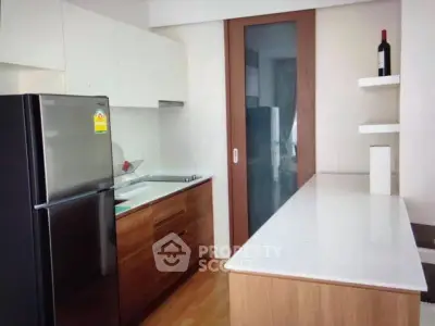 Modern kitchen with sleek cabinets and stainless steel fridge