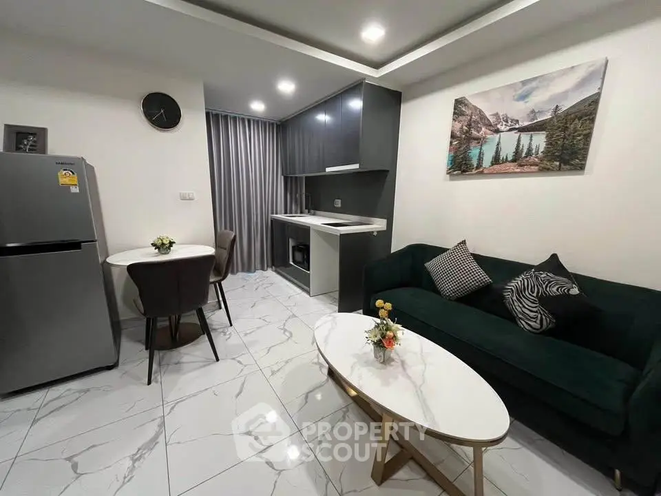Modern living room with sleek kitchen, elegant decor, and stylish furniture in a contemporary apartment.