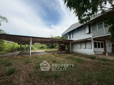 Spacious property with rustic charm and lush greenery, ideal for renovation or development.