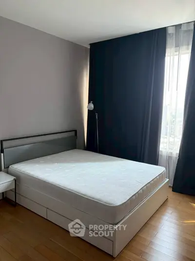 Modern bedroom with sleek design and large window for natural light