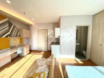 Bright modern studio apartment with wooden flooring and stylish decor