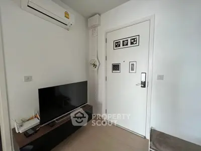 Modern living room with sleek TV setup and air conditioning