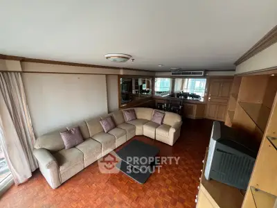 Spacious living room with elegant corner sofa and wooden flooring in a modern apartment.