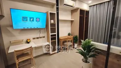 Modern study room with sleek furniture and smart TV in a stylish apartment.