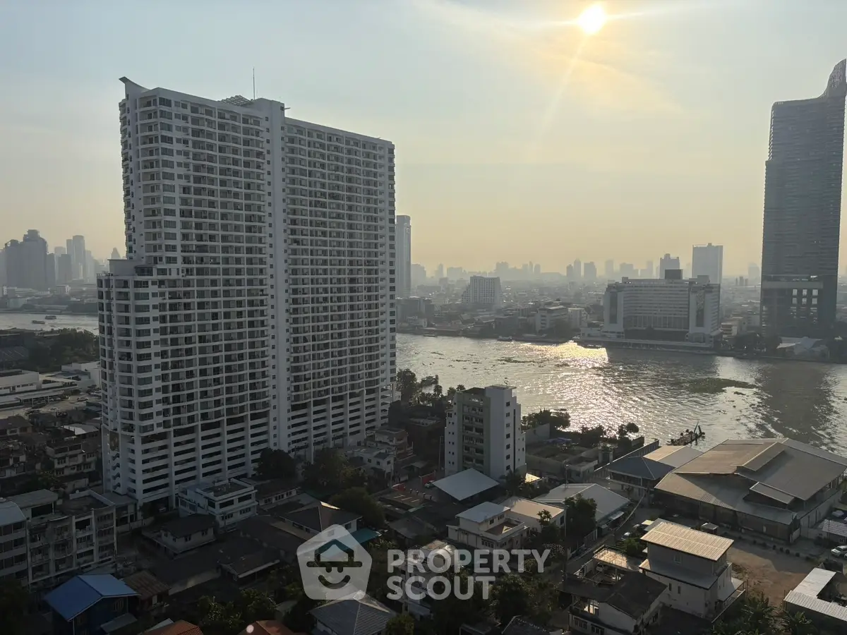 Stunning cityscape view with river and high-rise buildings at sunset, perfect for urban living.