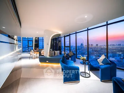 Luxurious modern living room with panoramic city view and elegant blue seating