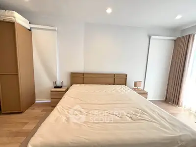 Spacious bedroom with modern furnishings and natural light