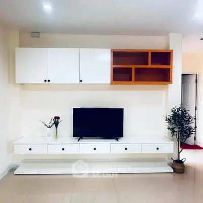 Modern living room with sleek white TV cabinet and stylish decor