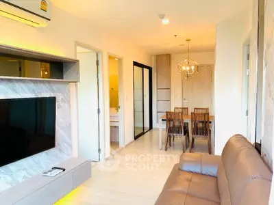 Modern living room with stylish decor and dining area in open layout apartment.
