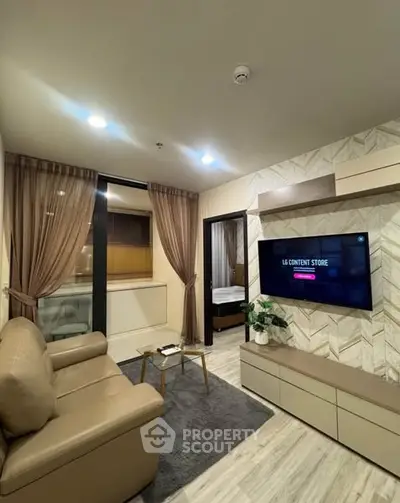 Modern living room with sleek furniture and wall-mounted TV in stylish apartment