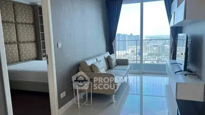 Modern apartment with stunning city view, featuring a cozy living room and adjacent bedroom.