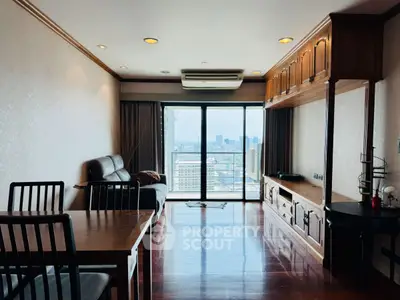 Spacious living room with city view, elegant wooden furniture, and large windows for natural light.