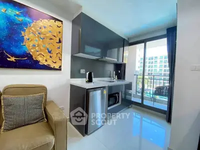 Modern compact kitchen with balcony view in stylish apartment