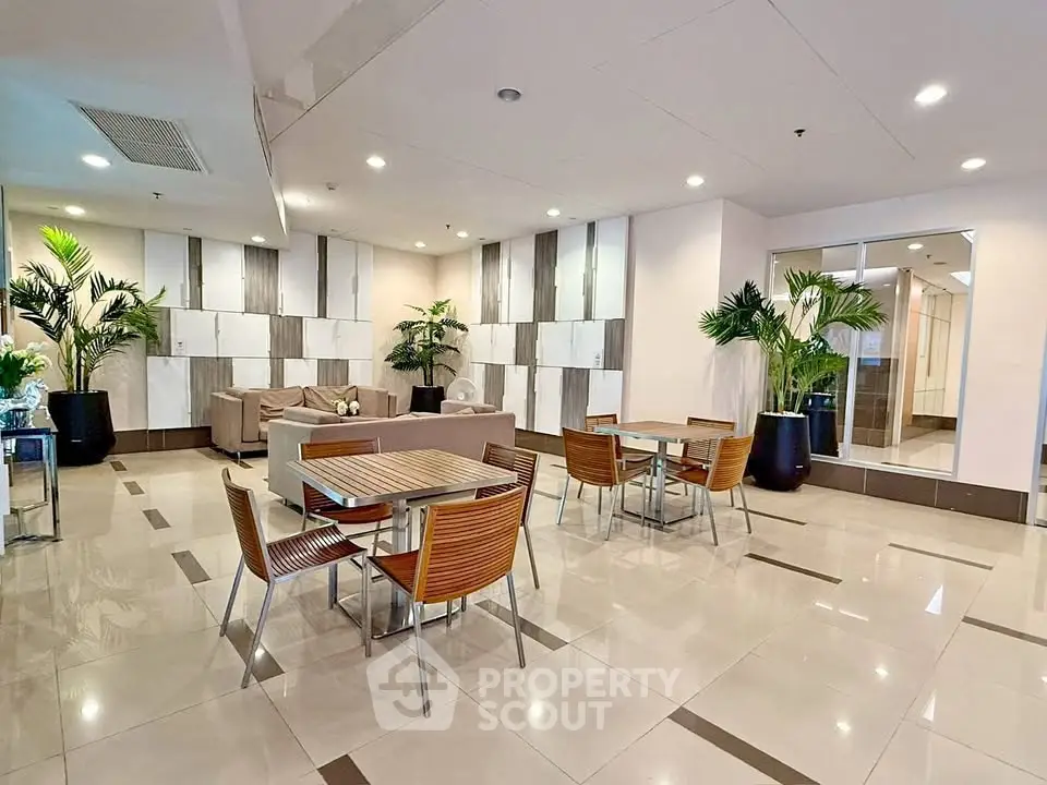 Modern communal area with stylish seating and decor in a contemporary building.