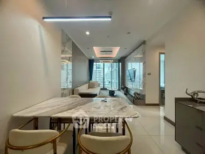 Modern living room with elegant marble dining table and city view from large windows.