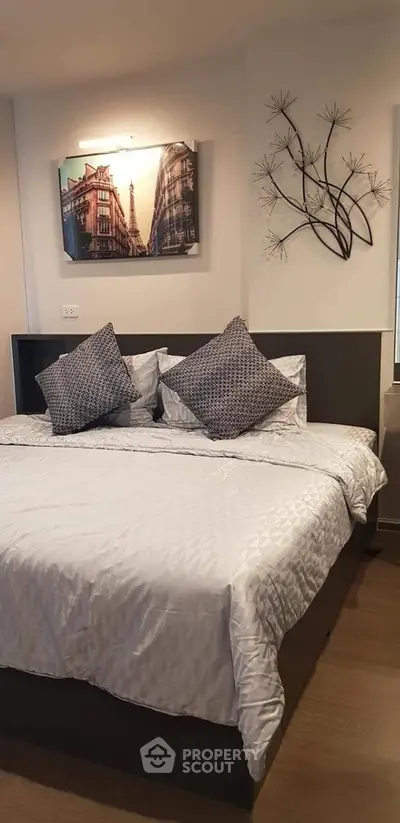 Cozy bedroom with stylish decor and comfortable bedding in modern apartment.
