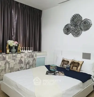 Cozy bedroom with elegant decor and stylish wall art, featuring a comfortable bed and chic curtains.