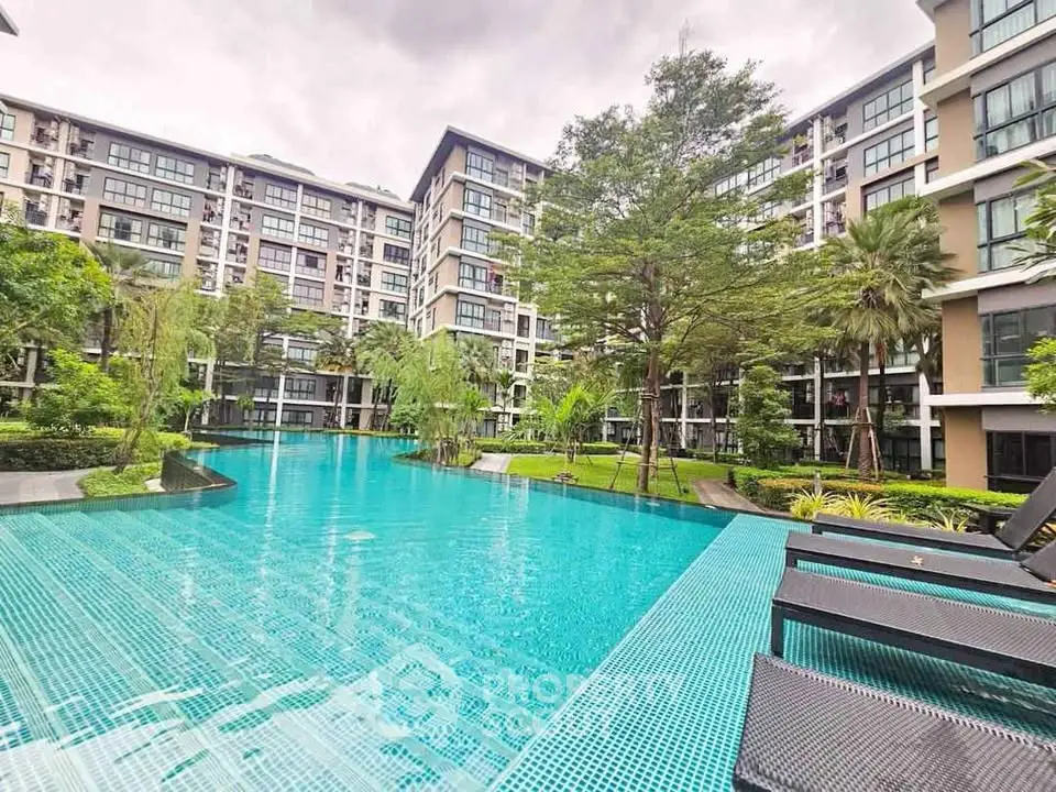 Luxurious condominium with stunning pool and lush greenery, perfect for modern living.