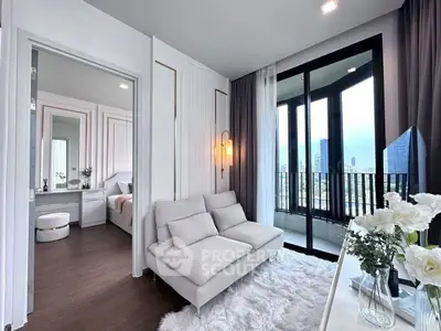 Modern living room with cozy sofa, fluffy rug, and balcony view in a stylish apartment.