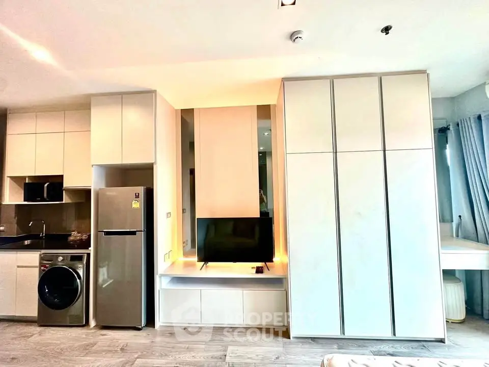 Modern apartment interior with sleek kitchen and built-in storage