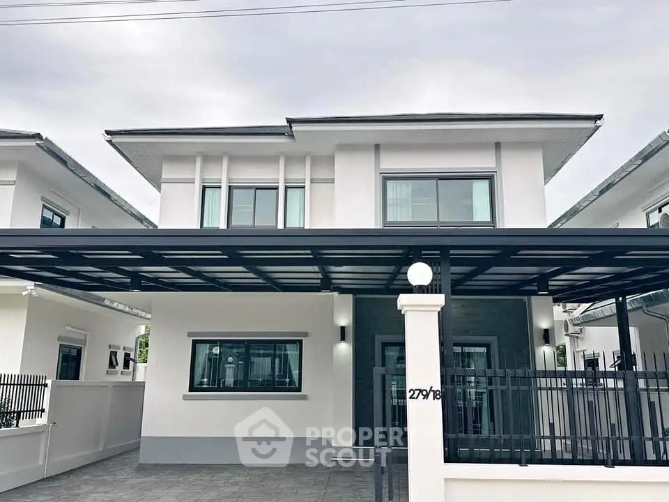 Modern two-story house with sleek design and spacious carport in suburban neighborhood.