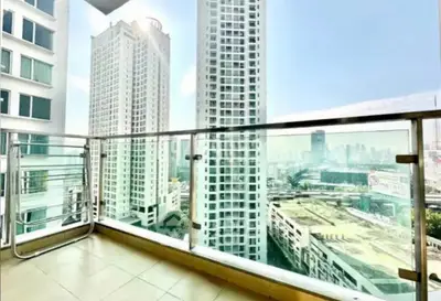 Spacious balcony with stunning cityscape view in modern high-rise apartment.