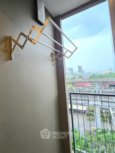 Modern balcony with city view and retractable clothes hanger.