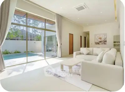 Luxurious living room with pool view and elegant decor in modern home