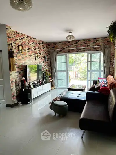 Stylish living room with modern decor and large windows opening to a garden view.