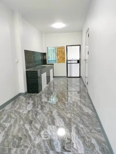 Modern kitchen with sleek tile flooring and stylish backsplash