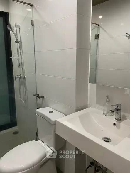 Modern bathroom with sleek fixtures and glass shower enclosure