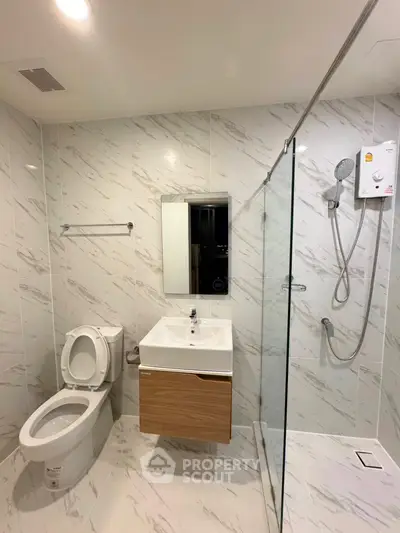 Modern bathroom with sleek fixtures and glass shower enclosure